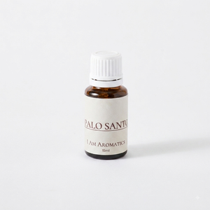 I Am Aromatics Palo Santo essential oil blend with bergamot and cedarwood, shown in a glass bottle for energy clearing.