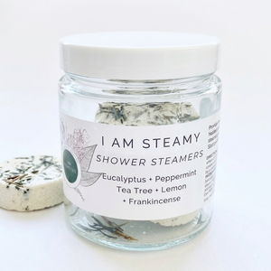 I Am Aromatics Menthol and Eucalyptus shower steamer discs for congestion relief, shown in a bathroom setting.