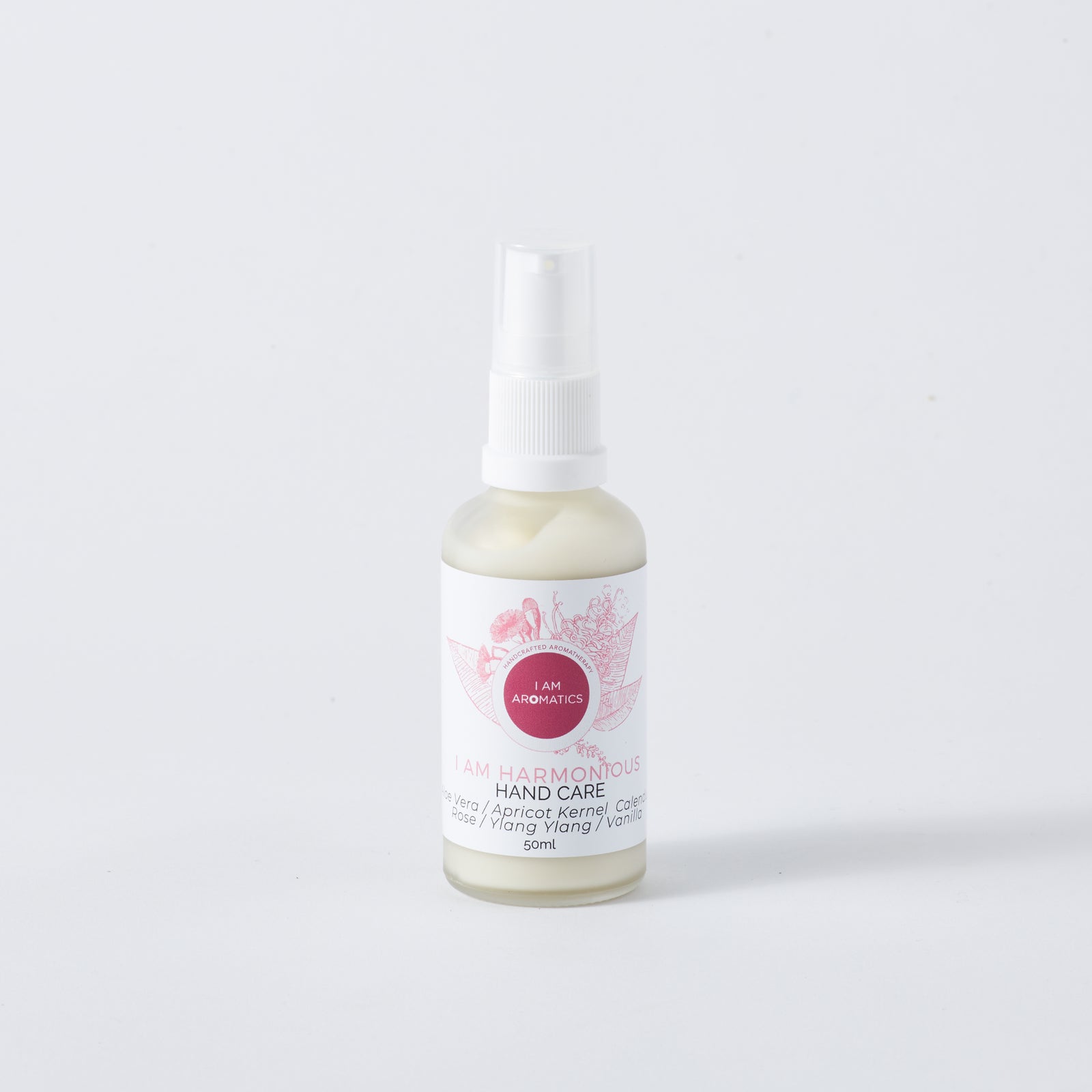 Harmonious hand care/cream in frosted glass bottle with white atomiser, pink logo and pink font 50mls