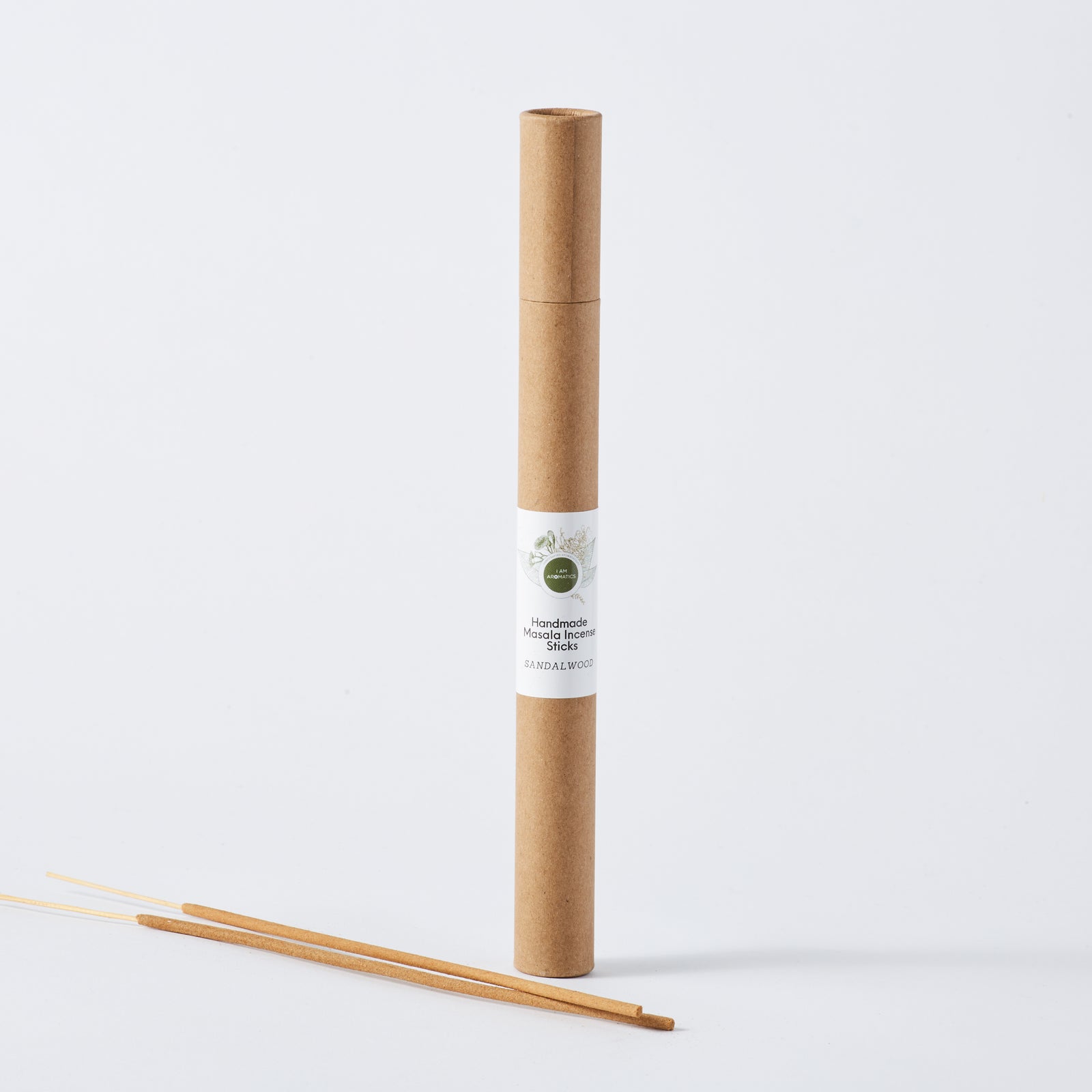 kraft brown paper container standing tall with white label and botanical logo. two sticks of incense laying beside